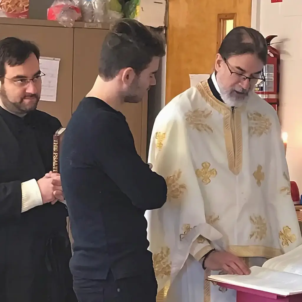 Parishioners and Father standing together and reading inside the church.
