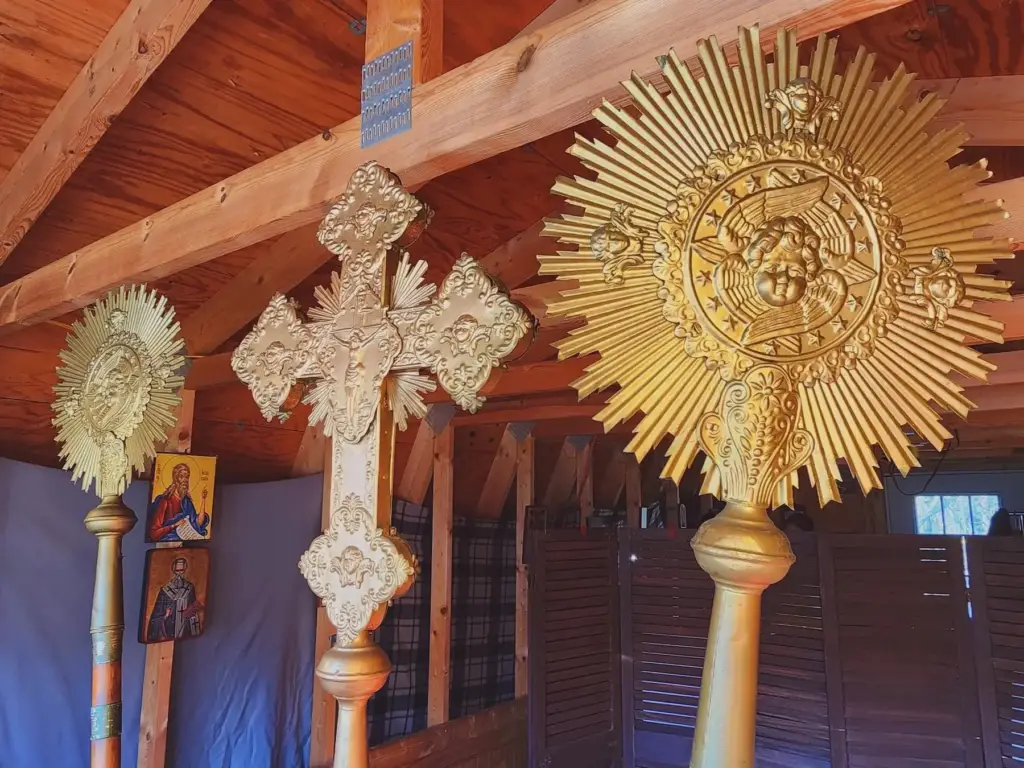Liturgical cross and fans displayed behind the altar.