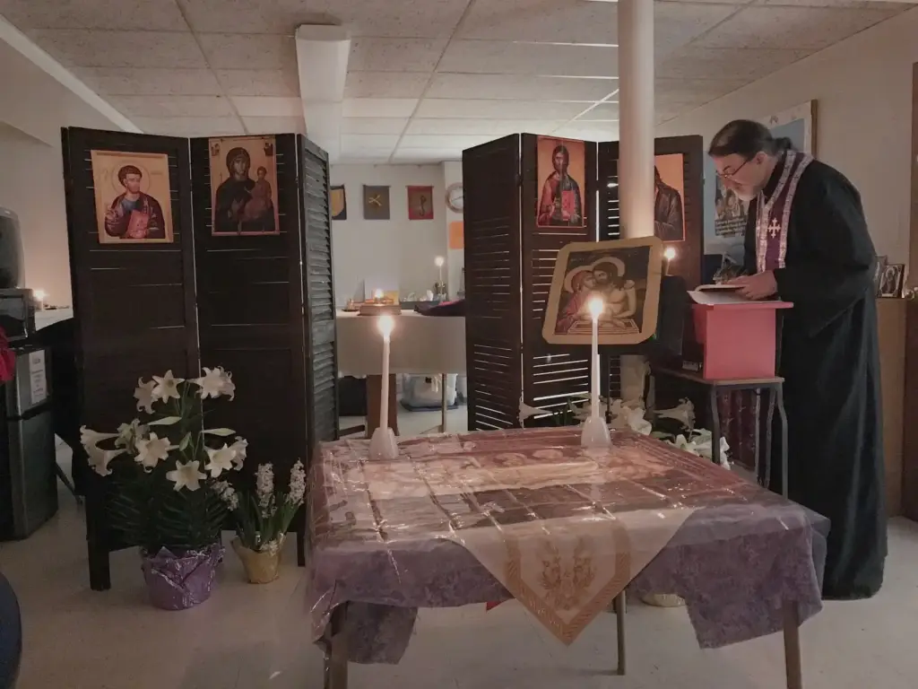 Father Gregory reading from the chant stand during service.
