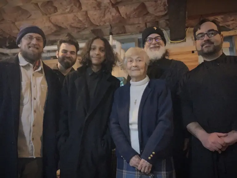 Parishioners and Father pose after a fellowship gathering.