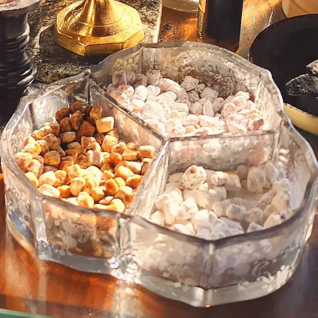 Close-up of a glass incense holder and three kinds of incense used during service.