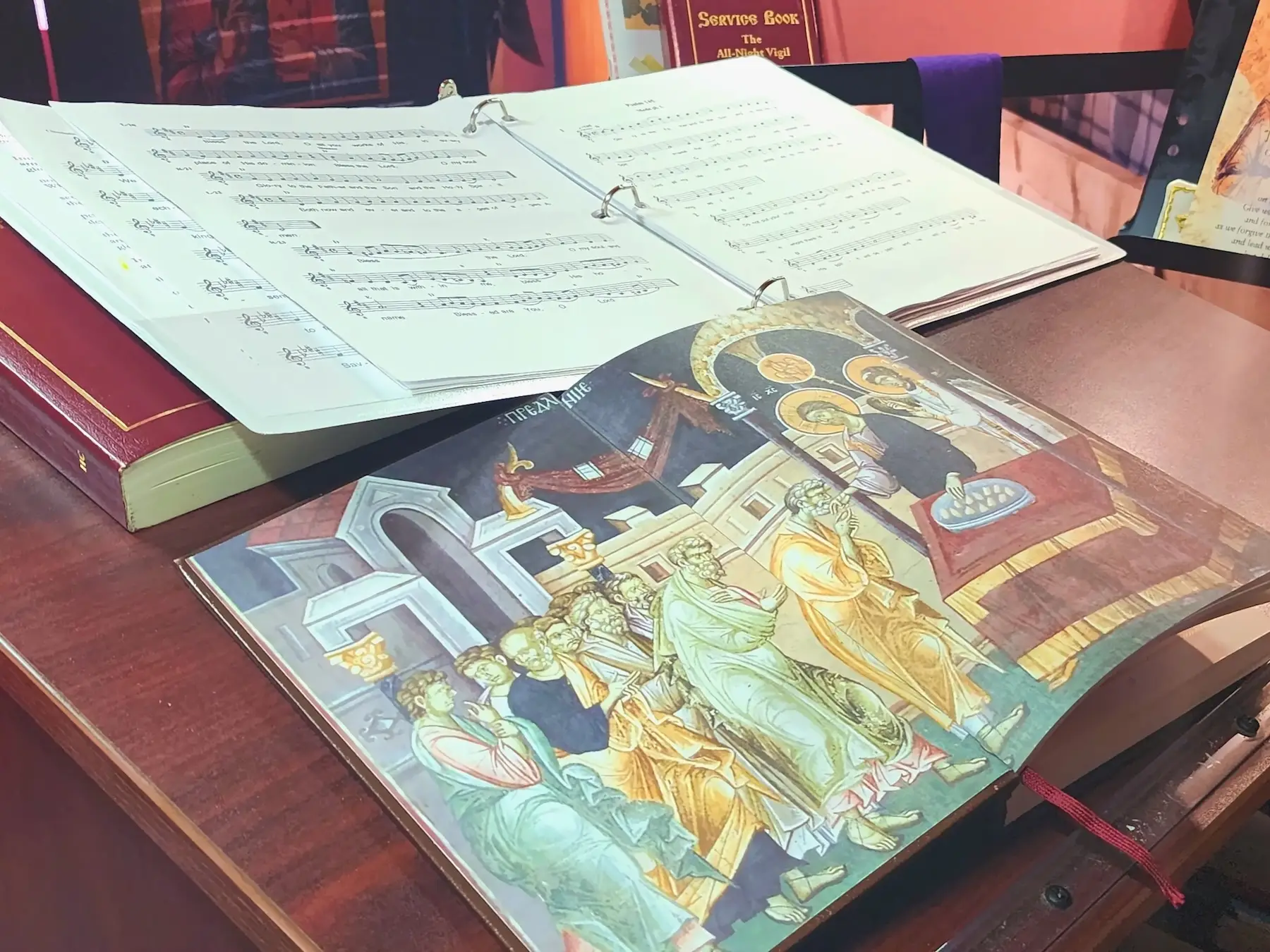 An open liturgical book turned to a page with an icon imprinted on it.