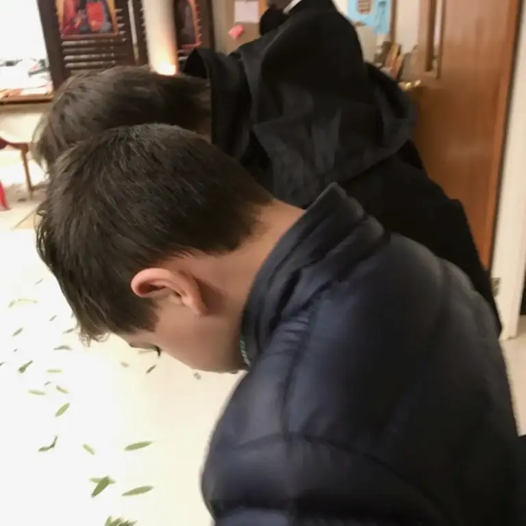 A young boy bowing during service.