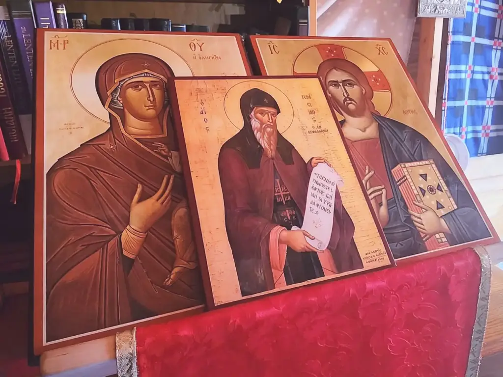 Three icons displayed on a wooden stand.