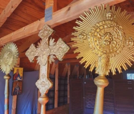 Liturgical cross and fans displayed behind the altar.