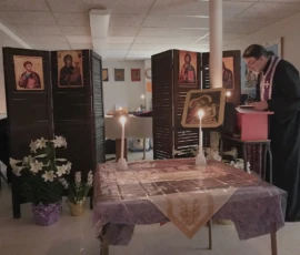 Father Gregory reading from the chant stand during service.