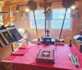 Full view of the altar with fans and a cross in the background.