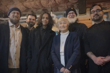 Parishioners and Father pose after a fellowship gathering.